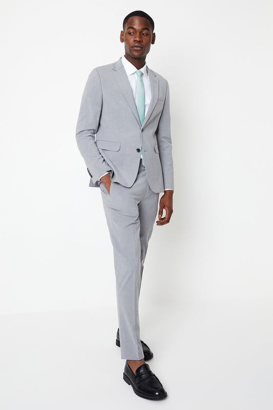 Introducing our Skinny Fit Essential Smart Jacket, perfect for any occasion. This jacket features a 2 button closure and a notch lapel, giving it a classic and timeless look. The twin back vent allows for ease of movement and added comfort. Made with a polyester viscose blend fabric with added stretch, to ensure a cool and comfortable fit all day long. Whether you're dressing up for a formal event or adding a touch of sophistication to your everyday look, our Skinny Fit Essential Smart Jacket is the perfect choice.