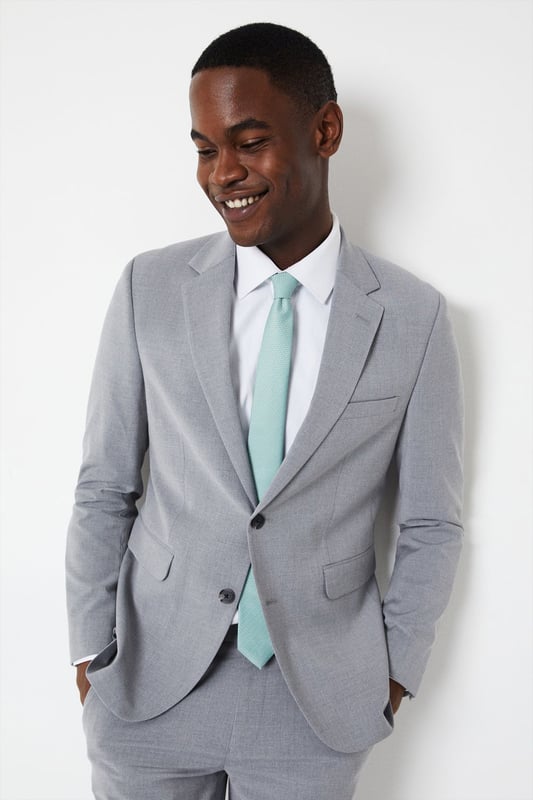 Introducing our Skinny Fit Essential Smart Jacket, perfect for any occasion. This jacket features a 2 button closure and a notch lapel, giving it a classic and timeless look. The twin back vent allows for ease of movement and added comfort. Made with a polyester viscose blend fabric with added stretch, to ensure a cool and comfortable fit all day long. Whether you're dressing up for a formal event or adding a touch of sophistication to your everyday look, our Skinny Fit Essential Smart Jacket is the perfect choice.
