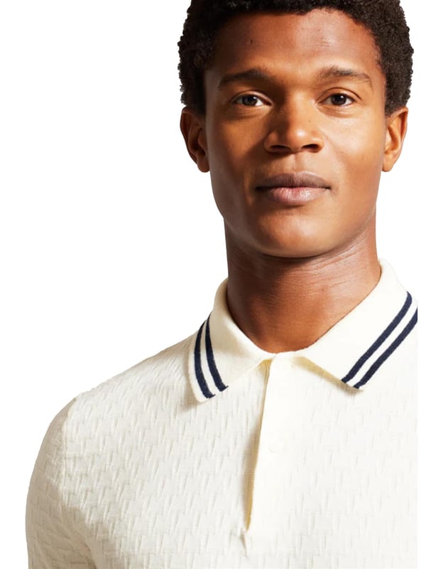 Elevate your everyday wardrobe with the MAHANA polo shirt, designed for effortless style and all-day comfort. Crafted from a premium wool blend, this polo offers a soft feel with a refined textured stitch for added sophistication. The classic button placket and short-sleeved design make it a versatile choice for both smart and casual occasions. Featuring a stylish striped collar, this polo blends traditional charm with modern detailing