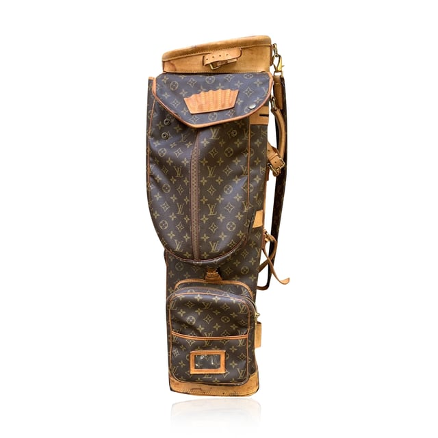 VINTAGE, RRP AS NEW
This vintage Louis Vuitton golf bag is a perfect blend of style and practicality, ideal for any discerning golfer who appreciates both form and function. Crafted from the iconic monogram canvas, this bag is finished with rich genuine leather accents and gold metal hardware, showcasing Louis Vuitton's timeless luxury. The bag is designed to hold a full set of golf clubs and includes a six-tee holder, ensuring that you're always ready for your game.  With three large zippered pockets and several flat pockets, you'll have ample space to store clothing, towels, golf balls, and even an umbrella for those unexpected weather changes. The side handle makes it easy to maneuver, while the padded and adjustable shoulder strap ensures comfort as you carry your gear. Additionally, the removable leather ID tag adds a personalized touch to this already exceptional piece.  Finished with "Louis Vuitton Paris - Made in France" engraved on the leather trim, this golf bag is not just a functional accessory but a statement of luxury and craftsmanship. Whether you're heading to the course or simply adding a classic piece to your collection, this Louis Vuitton golf bag is a standout choice. Condition Rating: C - USEDCondition Details: Many stains, scratches and darkness on leather parts (especially on the bottom). Some darkness on the hardware. Please check the photos carefully and ask if you need to know more details or if you have any doubts.Measurements (cm):Depth: 19.1Height: 87.6Length: 24.1Other Details: Dustbag? NoKeys? NoBox? No Measurments:  width: 191 mm length: 241 mm height: 876 mm