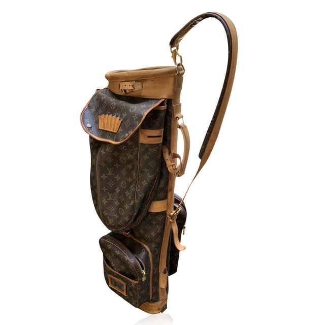 VINTAGE, RRP AS NEW
This vintage Louis Vuitton golf bag is a perfect blend of style and practicality, ideal for any discerning golfer who appreciates both form and function. Crafted from the iconic monogram canvas, this bag is finished with rich genuine leather accents and gold metal hardware, showcasing Louis Vuitton's timeless luxury. The bag is designed to hold a full set of golf clubs and includes a six-tee holder, ensuring that you're always ready for your game.  With three large zippered pockets and several flat pockets, you'll have ample space to store clothing, towels, golf balls, and even an umbrella for those unexpected weather changes. The side handle makes it easy to maneuver, while the padded and adjustable shoulder strap ensures comfort as you carry your gear. Additionally, the removable leather ID tag adds a personalized touch to this already exceptional piece.  Finished with "Louis Vuitton Paris - Made in France" engraved on the leather trim, this golf bag is not just a functional accessory but a statement of luxury and craftsmanship. Whether you're heading to the course or simply adding a classic piece to your collection, this Louis Vuitton golf bag is a standout choice. Condition Rating: C - USEDCondition Details: Many stains, scratches and darkness on leather parts (especially on the bottom). Some darkness on the hardware. Please check the photos carefully and ask if you need to know more details or if you have any doubts.Measurements (cm):Depth: 19.1Height: 87.6Length: 24.1Other Details: Dustbag? NoKeys? NoBox? No Measurments:  width: 191 mm length: 241 mm height: 876 mm
