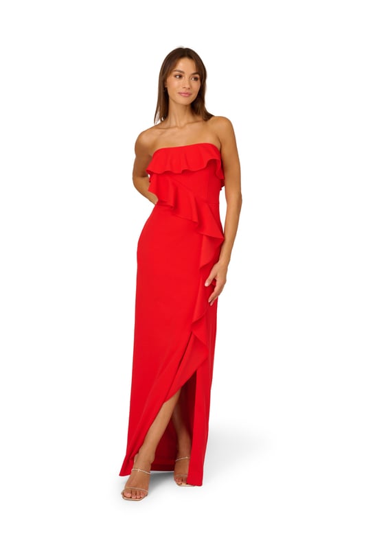 A lovely cascade of ruffles lend feminine charm to this strapless gown. This formal dress features a strapless bodice, column skirt with slit at the side, and ruffle trim that adorns the neckline and drapes elegantly across and down the gown. Crafted from knit crepe fabric with comfortable stretch, this strapless gown will be a showstopper for formal and black-tie affairs. A zipper closure at the centre back completes this elegant dress. Styled with gold accessories and a beaded clutch, you are ready for any invite that comes your way.