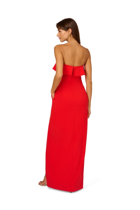 A lovely cascade of ruffles lend feminine charm to this strapless gown. This formal dress features a strapless bodice, column skirt with slit at the side, and ruffle trim that adorns the neckline and drapes elegantly across and down the gown. Crafted from knit crepe fabric with comfortable stretch, this strapless gown will be a showstopper for formal and black-tie affairs. A zipper closure at the centre back completes this elegant dress. Styled with gold accessories and a beaded clutch, you are ready for any invite that comes your way.