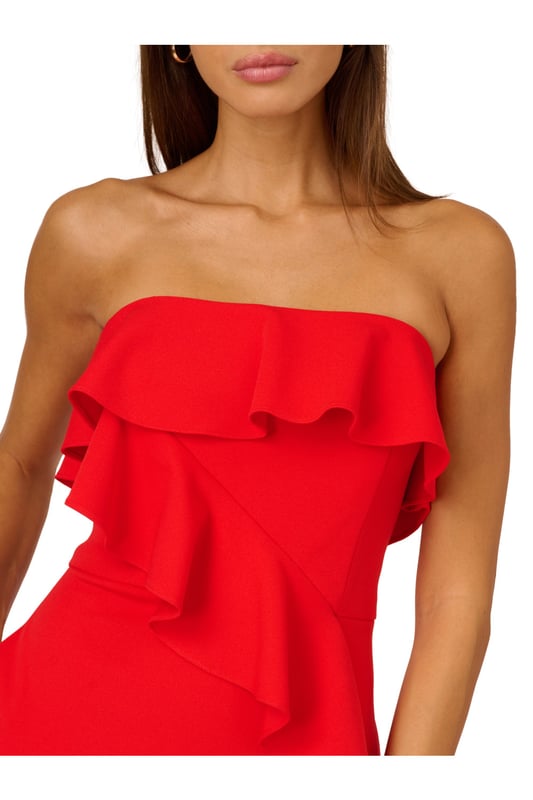 A lovely cascade of ruffles lend feminine charm to this strapless gown. This formal dress features a strapless bodice, column skirt with slit at the side, and ruffle trim that adorns the neckline and drapes elegantly across and down the gown. Crafted from knit crepe fabric with comfortable stretch, this strapless gown will be a showstopper for formal and black-tie affairs. A zipper closure at the centre back completes this elegant dress. Styled with gold accessories and a beaded clutch, you are ready for any invite that comes your way.