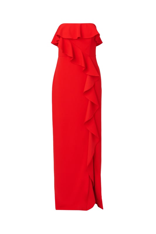 A lovely cascade of ruffles lend feminine charm to this strapless gown. This formal dress features a strapless bodice, column skirt with slit at the side, and ruffle trim that adorns the neckline and drapes elegantly across and down the gown. Crafted from knit crepe fabric with comfortable stretch, this strapless gown will be a showstopper for formal and black-tie affairs. A zipper closure at the centre back completes this elegant dress. Styled with gold accessories and a beaded clutch, you are ready for any invite that comes your way.