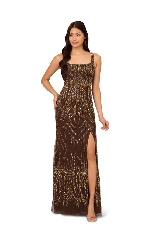 A sparkling night under the stars starts with this beaded mermaid gown. This formal dress features a square neckline, tank straps, a fitted silhouette, and a mermaid skirt. Crafted from mesh knit fabric and embellished throughout by figure-flattering sequin beaded designs, this evening gown is a showstopping look for formal wedding and black-tie events. A hidden zipper closure at the square centre back completes this elegant dress. Paired with metallic heels and crystal jewels, this black-tie dress will make a splash when you RSVP yes.