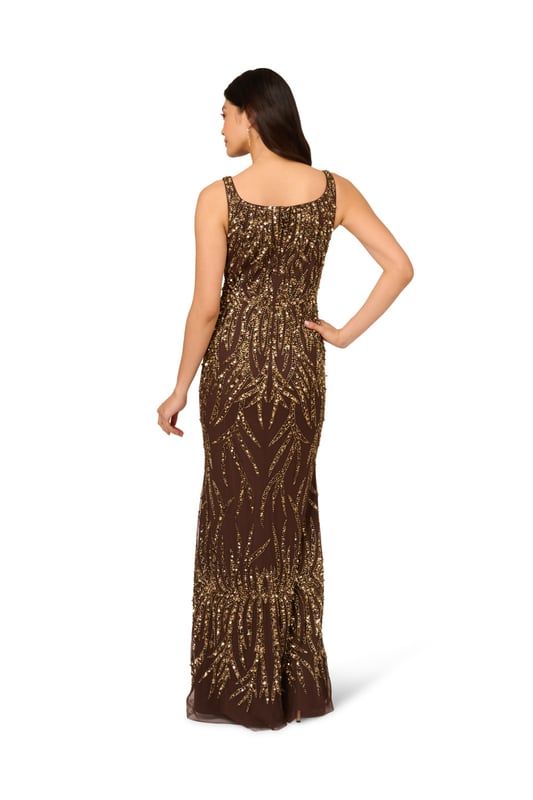 A sparkling night under the stars starts with this beaded mermaid gown. This formal dress features a square neckline, tank straps, a fitted silhouette, and a mermaid skirt. Crafted from mesh knit fabric and embellished throughout by figure-flattering sequin beaded designs, this evening gown is a showstopping look for formal wedding and black-tie events. A hidden zipper closure at the square centre back completes this elegant dress. Paired with metallic heels and crystal jewels, this black-tie dress will make a splash when you RSVP yes.