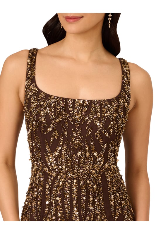 A sparkling night under the stars starts with this beaded mermaid gown. This formal dress features a square neckline, tank straps, a fitted silhouette, and a mermaid skirt. Crafted from mesh knit fabric and embellished throughout by figure-flattering sequin beaded designs, this evening gown is a showstopping look for formal wedding and black-tie events. A hidden zipper closure at the square centre back completes this elegant dress. Paired with metallic heels and crystal jewels, this black-tie dress will make a splash when you RSVP yes.