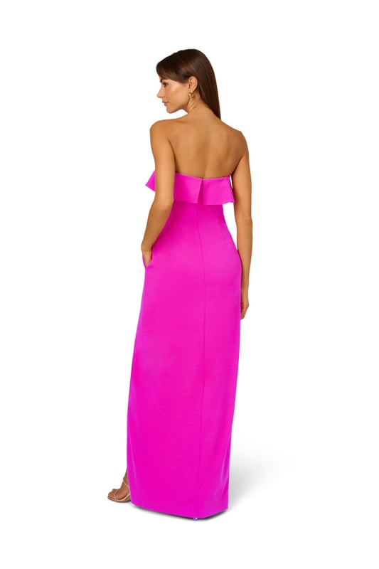 A lovely cascade of ruffles lend feminine charm to this strapless gown. This formal dress features a strapless bodice, column skirt with slit at the side, and ruffle trim that adorns the neckline and drapes elegantly across and down the gown. Crafted from knit crepe fabric with comfortable stretch, this strapless gown will be a showstopper for formal and black-tie affairs. A zipper closure at the center back completes this elegant dress. Styled with gold accessories and a beaded clutch, you are ready for any invite that comes your way.