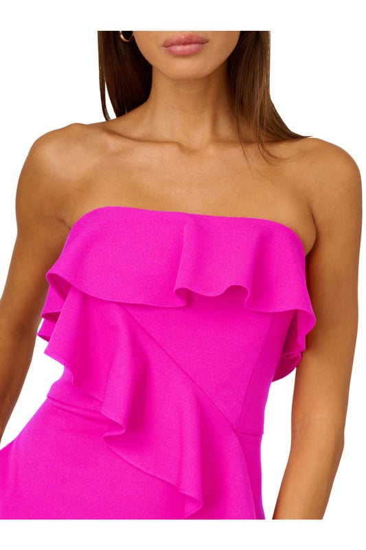A lovely cascade of ruffles lend feminine charm to this strapless gown. This formal dress features a strapless bodice, column skirt with slit at the side, and ruffle trim that adorns the neckline and drapes elegantly across and down the gown. Crafted from knit crepe fabric with comfortable stretch, this strapless gown will be a showstopper for formal and black-tie affairs. A zipper closure at the center back completes this elegant dress. Styled with gold accessories and a beaded clutch, you are ready for any invite that comes your way.