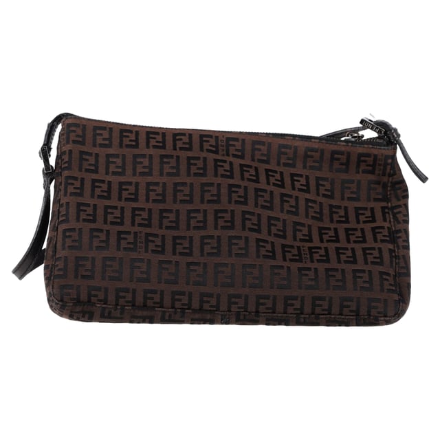 VINTAGE, RRP AS NEW
The Fendi Zucca FF Baguette Shoulder Bag in Brown Canvas is a bold and iconic accessory, featuring the signature FF monogram that gives it a timeless yet contemporary appeal. Crafted from durable canvas, this bag offers both style and functionality with its compact size and versatile shoulder strap. Pair it with a sleek black dress and heels for a sophisticated evening look, or wear it with jeans and a blazer for a chic, everyday ensemble. The warm brown tones of the canvas make it a versatile addition to any wardrobe, effortlessly complementing both casual and formal outfits.

 Fendi Zucca FF Baguette Shoulder Bag in Brown Canvas

Condition: Very good
Signs of wear: No retail tag, Minor sign of wear., Lightly used but very well maintained. Minor creasing, light worn corners, light scratches.
Packaging: Box
Color: Brown | ochre
Material: Canvas 
Size: One Size | One Size
Measurements: Width: 90; Height: 160; Length: 250; Handle drop: 200; Strap length: 470
SKU: NAPPUGBBA463283W