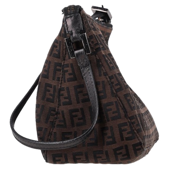 VINTAGE, RRP AS NEW
The Fendi Zucca FF Baguette Shoulder Bag in Brown Canvas is a bold and iconic accessory, featuring the signature FF monogram that gives it a timeless yet contemporary appeal. Crafted from durable canvas, this bag offers both style and functionality with its compact size and versatile shoulder strap. Pair it with a sleek black dress and heels for a sophisticated evening look, or wear it with jeans and a blazer for a chic, everyday ensemble. The warm brown tones of the canvas make it a versatile addition to any wardrobe, effortlessly complementing both casual and formal outfits.

 Fendi Zucca FF Baguette Shoulder Bag in Brown Canvas

Condition: Very good
Signs of wear: No retail tag, Minor sign of wear., Lightly used but very well maintained. Minor creasing, light worn corners, light scratches.
Packaging: Box
Color: Brown | ochre
Material: Canvas 
Size: One Size | One Size
Measurements: Width: 90; Height: 160; Length: 250; Handle drop: 200; Strap length: 470
SKU: NAPPUGBBA463283W