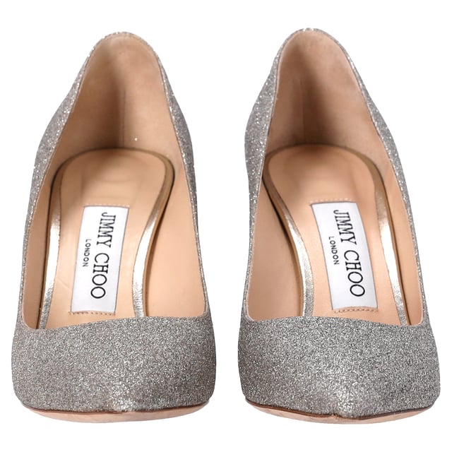 VINTAGE, RRP AS NEW
Step into elegance and sparkle with the Jimmy Choo Romy Pumps in silver glitter. These stunning heels feature a shimmering silver-tone glitter design that catches the light with every step. The 85mm stiletto heel offers just the right amount of height, while the pointed toe enhances the sleek, sophisticated silhouette. Finished with a branded leather insole and leather sole, these pumps are a perfect blend of comfort and luxury.

 Includes Box

Jimmy Choo Romy Pumps in Silver Glitter
Condition: very good
Signs of wear: Include Box., No visible sign of wear. No Mark at insole., Used but well maintained. Moderate creasing and marks at surface, wear at soles or replaced soles.
Packaging: Box
Color: silver
Material: Glitter | glitter
Size: EU | 35
Measurements: Heel height: 80; Insole length: 230
SKU: TONPUDESH462815W