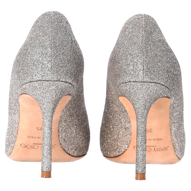 VINTAGE, RRP AS NEW
Step into elegance and sparkle with the Jimmy Choo Romy Pumps in silver glitter. These stunning heels feature a shimmering silver-tone glitter design that catches the light with every step. The 85mm stiletto heel offers just the right amount of height, while the pointed toe enhances the sleek, sophisticated silhouette. Finished with a branded leather insole and leather sole, these pumps are a perfect blend of comfort and luxury.

 Includes Box

Jimmy Choo Romy Pumps in Silver Glitter
Condition: very good
Signs of wear: Include Box., No visible sign of wear. No Mark at insole., Used but well maintained. Moderate creasing and marks at surface, wear at soles or replaced soles.
Packaging: Box
Color: silver
Material: Glitter | glitter
Size: EU | 35
Measurements: Heel height: 80; Insole length: 230
SKU: TONPUDESH462815W