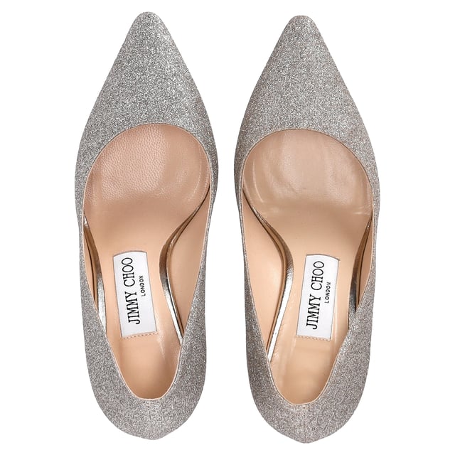 VINTAGE, RRP AS NEW
Step into elegance and sparkle with the Jimmy Choo Romy Pumps in silver glitter. These stunning heels feature a shimmering silver-tone glitter design that catches the light with every step. The 85mm stiletto heel offers just the right amount of height, while the pointed toe enhances the sleek, sophisticated silhouette. Finished with a branded leather insole and leather sole, these pumps are a perfect blend of comfort and luxury.

 Includes Box

Jimmy Choo Romy Pumps in Silver Glitter
Condition: very good
Signs of wear: Include Box., No visible sign of wear. No Mark at insole., Used but well maintained. Moderate creasing and marks at surface, wear at soles or replaced soles.
Packaging: Box
Color: silver
Material: Glitter | glitter
Size: EU | 35
Measurements: Heel height: 80; Insole length: 230
SKU: TONPUDESH462815W