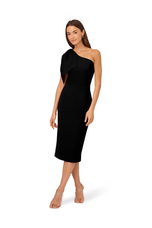 Own every room you walk into in this timeless midi dress. This chic dress features a one shoulder neckline, fitted body, and a mid-length skirt. Crafted from crepe fabric, this cocktail dress has a large bow accent at the shoulder. A zipper closure and slit at the centre back of this midi dress complete the design. Accessorize with your favourite heels and statement earrings for a look that will shine no matter the occasion.