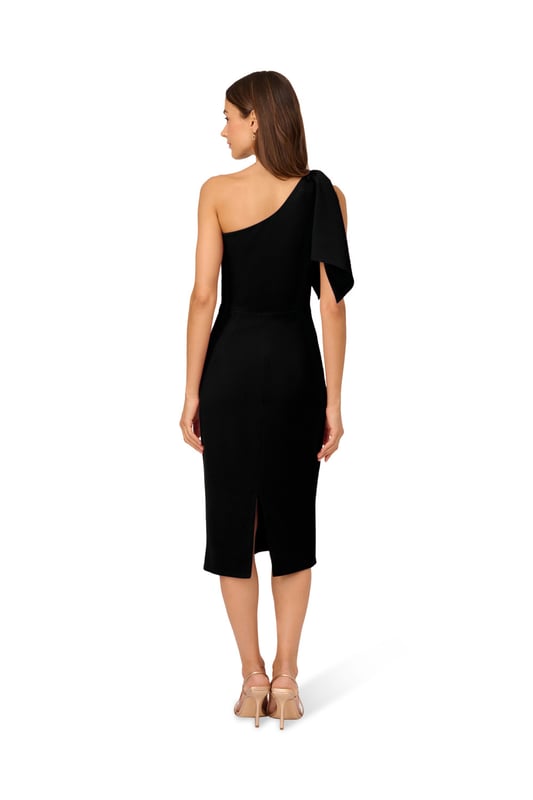 Own every room you walk into in this timeless midi dress. This chic dress features a one shoulder neckline, fitted body, and a mid-length skirt. Crafted from crepe fabric, this cocktail dress has a large bow accent at the shoulder. A zipper closure and slit at the centre back of this midi dress complete the design. Accessorize with your favourite heels and statement earrings for a look that will shine no matter the occasion.