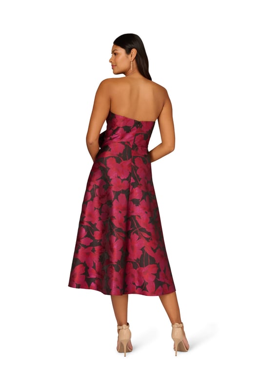 Make a stunning entrance in this strapless midi dress. This cocktail dress features a bow-trimmed bodice, a strapless neckline with notched cutout, and a full midi skirt with pockets. Designed with floral jacquard fabric from China, this fit and flare dress is a classic look that has been elevated with modern details. A hidden zipper back closure completes this floral party dress. Accessorized with heels and your favourite clutch, this strapless party dress is bound to shine for years to come.