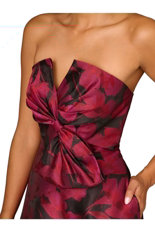 Make a stunning entrance in this strapless midi dress. This cocktail dress features a bow-trimmed bodice, a strapless neckline with notched cutout, and a full midi skirt with pockets. Designed with floral jacquard fabric from China, this fit and flare dress is a classic look that has been elevated with modern details. A hidden zipper back closure completes this floral party dress. Accessorized with heels and your favourite clutch, this strapless party dress is bound to shine for years to come.