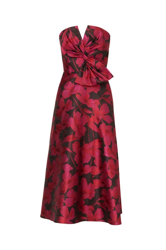 Make a stunning entrance in this strapless midi dress. This cocktail dress features a bow-trimmed bodice, a strapless neckline with notched cutout, and a full midi skirt with pockets. Designed with floral jacquard fabric from China, this fit and flare dress is a classic look that has been elevated with modern details. A hidden zipper back closure completes this floral party dress. Accessorized with heels and your favourite clutch, this strapless party dress is bound to shine for years to come.