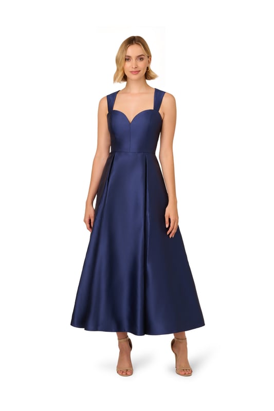 Classic elegance in a garment, this ankle-length sleeveless dress is constructed in crisp and lustrous Mikado fabric. Tailored details harken back to 50s couture with a sweetheart neckline and fit and flare silhouette. The back features a wide cutout at the top for a modern touch. A back zipper and side pockets finish the look.