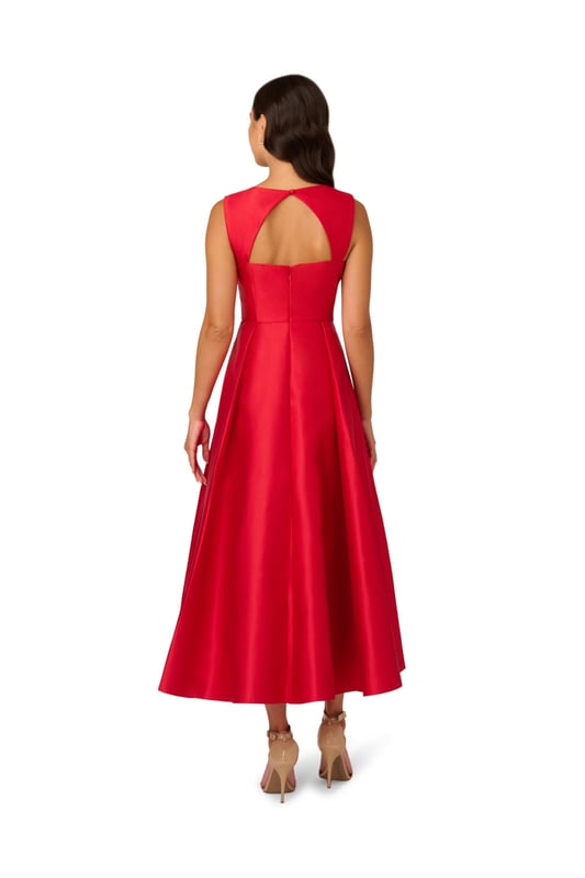Classic elegance in a garment, this ankle-length sleeveless dress is constructed in crisp and lustrous Mikado fabric. Tailored details harken back to 50s couture with a sweetheart neckline and fit and flare silhouette. The back features a wide cutout at the top for a modern touch. A back zipper and side pockets finish the look.