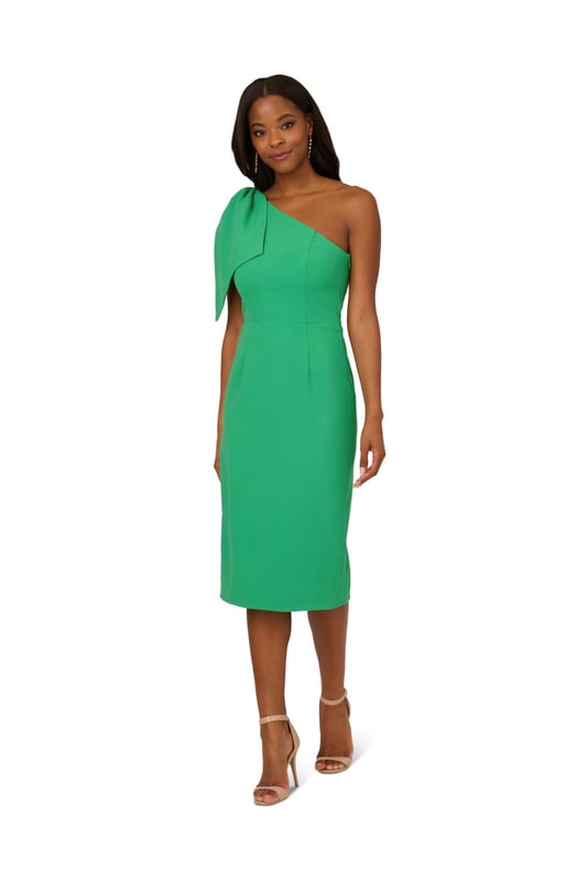 Own every room you walk into in this timeless midi dress. This chic dress features a one shoulder neckline, fitted body, and a mid-length skirt. Crafted from crepe fabric, this cocktail dress has a large bow accent at the shoulder. A zipper closure and slit at the centre back of this midi dress complete the design. Accessorize with your favourite heels and statement earrings for a look that will shine no matter the occasion.
