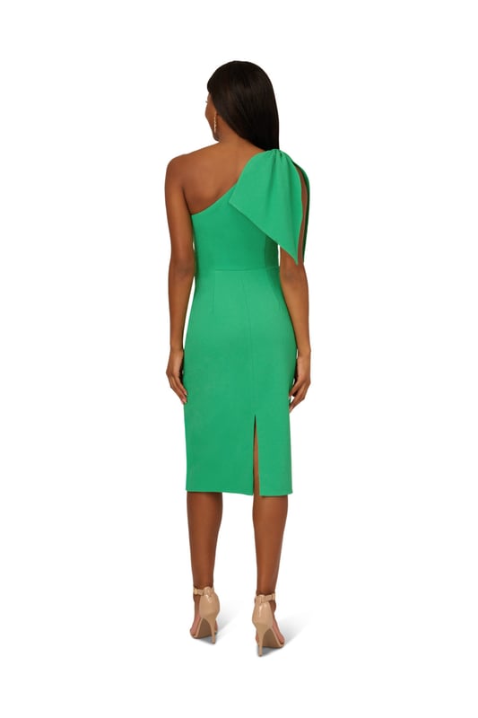 Own every room you walk into in this timeless midi dress. This chic dress features a one shoulder neckline, fitted body, and a mid-length skirt. Crafted from crepe fabric, this cocktail dress has a large bow accent at the shoulder. A zipper closure and slit at the centre back of this midi dress complete the design. Accessorize with your favourite heels and statement earrings for a look that will shine no matter the occasion.