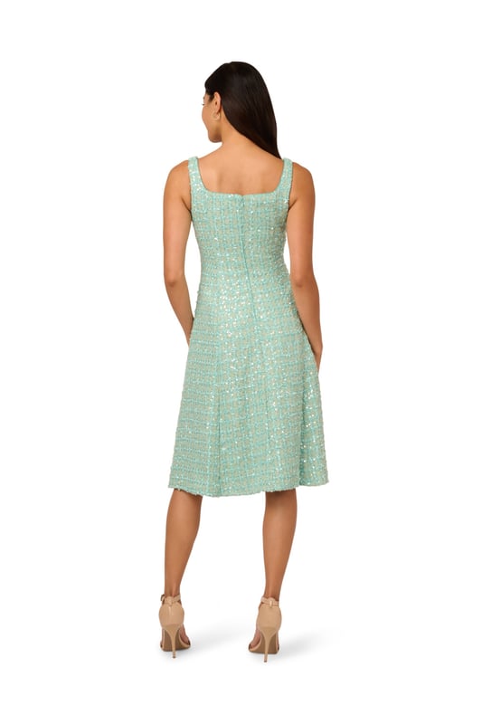 A square neckline and a fit-and-flare silhouette give this minty green womens midi dress a classic silhouette. The modern twist on the look is the pretty textured fabric. A tweed inspired boucle finished in sheer but shimmering sequins. The back zipper, princess seams, and a no-waist-seam construction give the bodice its sleek fit. Wear this cute sleeveless dress for a sparkly update on classic prim and polished style.