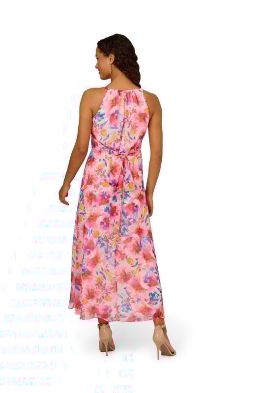 Bright and bold, this halter gown is a hit for every event. This formal dress features a halter bodice with shirred details, a soft skirt, and a self-tie waist. Crafted from floral printed chiffon fabric, this ankle-length dress has minimal stretch. A hidden zipper closure at the centre back of this dress completes the design. A pretty look for formal parties and black-tie weddings, this floral gown is a head-turner.