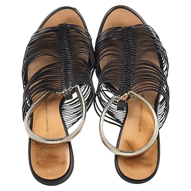 VINTAGE, RRP AS NEW
 Step into elegance with the Giuseppe Zanotti Strappy Sandals in Black Leather. Expertly crafted from dark leather, these sandals feature multiple slender straps that beautifully wrap around the foot, accented with gold-tone details that exude subtle glamour. The 10 cm heels provide just the right amount of lift, enhancing your silhouette while maintaining comfort and stability with sturdy soles. Perfect for a night out or a special occasion, these sandals offer a refined, sophisticated look that pairs well with a variety of outfits.with Dust bag

Giuseppe Zanotti Strappy Sandals in Black Leather
Condition: good
Signs of wear: Minor markings, Lightly used but very well maintained. Minor mark at soles & creasing, light scuffing at the soles and heels.
Packaging: Dust bag
Color: Black
Material: Leather | leather
Size: EU | 37
Measurements: Heel height: 90; Insole length: 240
SKU: NAPPUGBSH462133W