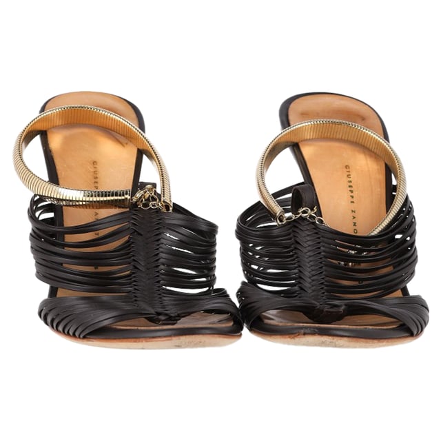 VINTAGE, RRP AS NEW
 Step into elegance with the Giuseppe Zanotti Strappy Sandals in Black Leather. Expertly crafted from dark leather, these sandals feature multiple slender straps that beautifully wrap around the foot, accented with gold-tone details that exude subtle glamour. The 10 cm heels provide just the right amount of lift, enhancing your silhouette while maintaining comfort and stability with sturdy soles. Perfect for a night out or a special occasion, these sandals offer a refined, sophisticated look that pairs well with a variety of outfits.with Dust bag

Giuseppe Zanotti Strappy Sandals in Black Leather
Condition: good
Signs of wear: Minor markings, Lightly used but very well maintained. Minor mark at soles & creasing, light scuffing at the soles and heels.
Packaging: Dust bag
Color: Black
Material: Leather | leather
Size: EU | 37
Measurements: Heel height: 90; Insole length: 240
SKU: NAPPUGBSH462133W