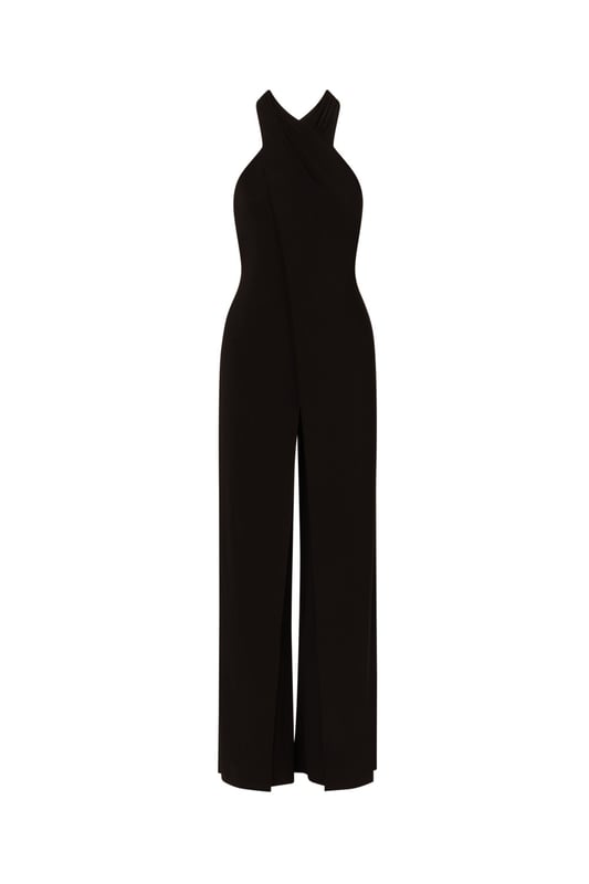 Elevate your wardrobe with this chic black jumpsuit, crafted from luxurious knit jersey fabric for both comfort and style. The halter neckline and sleeveless design exude modern sophistication, while the front fly skirt overlap detail adds a touch of effortless elegance. Finished with a zipper closure at the centre back for a seamless fit, this halter jumpsuit seamlessly blends fashion-forward design with practicality. Perfect for black-tie events or stylish evenings out, this formal jumpsuit for women promises to make a lasting impression with its impeccable craftsmanship and flattering silhouette.