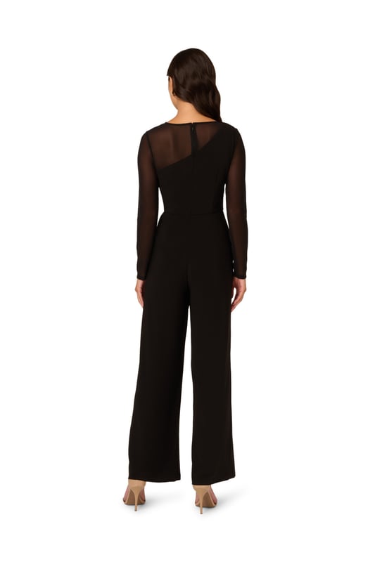 Mesh details add depth and texture to this monochrome wide leg long sleeve jumpsuit. The zip-back bodice features a one-shoulder stretch jersey design with mesh sleeves and shoulders creating a unique asymmetrical illusion neckline. Matching stretch jersey trousers in a wide cut complete this sleek and sophisticated all-in-one ensemble.