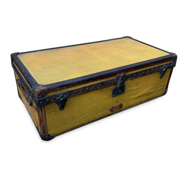 VINTAGE, RRP AS NEW
Step back in time and embrace a piece of history with this rare Louis Vuitton cabin travel trunk, dating back to the early 20th century (circa 1910-1920). Crafted from the iconic 'Vuittonite' canvas, this trunk showcases the craftsmanship and innovation that helped define Louis Vuitton's legacy. The chocolate leather trim and handles add a rich, classic touch to the piece, while the main lock, reinforced with two complementary trunk latches, reflects the brand's dedication to both style and security.  Inside, the trunk reveals its original beige canvas lining, with the inner lid studded for added structure and style. The presence of the original Louis Vuitton tag inside further solidifies its ity and historical significance. This trunk isn't just a functional travel piece; it's a timeless treasure, perfect for adding a sophisticated, vintage flair to your home or office decor. Own a tangible piece of Louis Vuitton history and experience the luxury of the past with this stunning, collectible trunk. Condition Rating: B - VERY GOOD CONDITIONCondition Details: The original orange color has turned to yellow with the effect of time and light. Many signs of darkness and scratches allover. Metal trim shows many cracks and came off in some point. Some green marks on metal parts. Leather trim has darkned and shows some cracks. Keys are missing. The interior shows some darkness and a hole on the lining, on the reverse of the lid. The interior tray is missing. Its general condition is very good, considering its age. Please keep in mind that the trunk dates back to the early twentieth century and therefore has signs of wear due to age and use. Please check the photos carefully and ask if you need to know more details or if you have any doubts.Measurements (cm):Depth: 33.0Height: 53.3Length: 100.3Other Details: Dustbag? NoKeys? NoBox? No Measurments:  width: 330 mm length: 1003 mm height: 533 mm