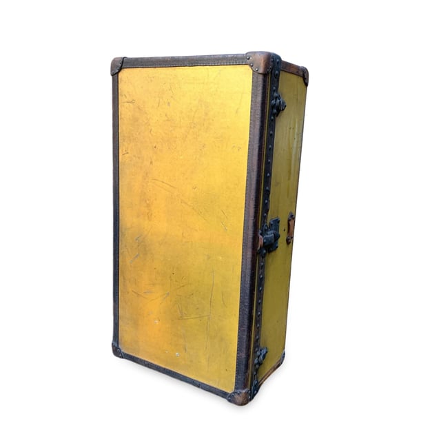 VINTAGE, RRP AS NEW
Step back in time and embrace a piece of history with this rare Louis Vuitton cabin travel trunk, dating back to the early 20th century (circa 1910-1920). Crafted from the iconic 'Vuittonite' canvas, this trunk showcases the craftsmanship and innovation that helped define Louis Vuitton's legacy. The chocolate leather trim and handles add a rich, classic touch to the piece, while the main lock, reinforced with two complementary trunk latches, reflects the brand's dedication to both style and security.  Inside, the trunk reveals its original beige canvas lining, with the inner lid studded for added structure and style. The presence of the original Louis Vuitton tag inside further solidifies its ity and historical significance. This trunk isn't just a functional travel piece; it's a timeless treasure, perfect for adding a sophisticated, vintage flair to your home or office decor. Own a tangible piece of Louis Vuitton history and experience the luxury of the past with this stunning, collectible trunk. Condition Rating: B - VERY GOOD CONDITIONCondition Details: The original orange color has turned to yellow with the effect of time and light. Many signs of darkness and scratches allover. Metal trim shows many cracks and came off in some point. Some green marks on metal parts. Leather trim has darkned and shows some cracks. Keys are missing. The interior shows some darkness and a hole on the lining, on the reverse of the lid. The interior tray is missing. Its general condition is very good, considering its age. Please keep in mind that the trunk dates back to the early twentieth century and therefore has signs of wear due to age and use. Please check the photos carefully and ask if you need to know more details or if you have any doubts.Measurements (cm):Depth: 33.0Height: 53.3Length: 100.3Other Details: Dustbag? NoKeys? NoBox? No Measurments:  width: 330 mm length: 1003 mm height: 533 mm