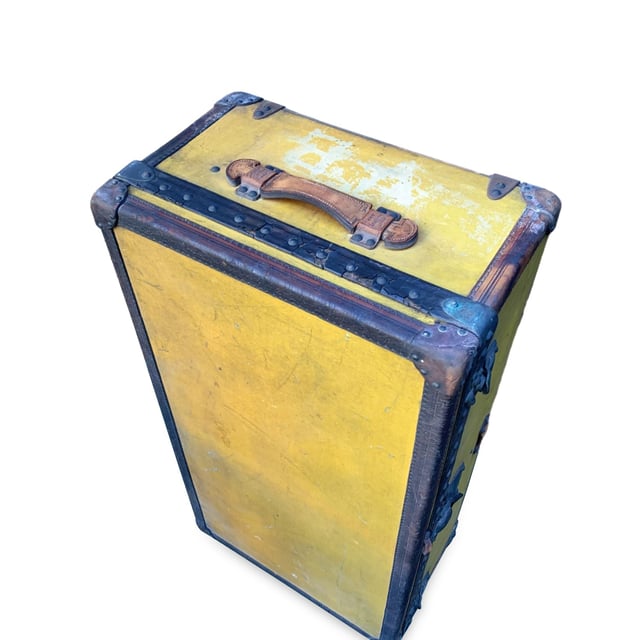 VINTAGE, RRP AS NEW
Step back in time and embrace a piece of history with this rare Louis Vuitton cabin travel trunk, dating back to the early 20th century (circa 1910-1920). Crafted from the iconic 'Vuittonite' canvas, this trunk showcases the craftsmanship and innovation that helped define Louis Vuitton's legacy. The chocolate leather trim and handles add a rich, classic touch to the piece, while the main lock, reinforced with two complementary trunk latches, reflects the brand's dedication to both style and security.  Inside, the trunk reveals its original beige canvas lining, with the inner lid studded for added structure and style. The presence of the original Louis Vuitton tag inside further solidifies its ity and historical significance. This trunk isn't just a functional travel piece; it's a timeless treasure, perfect for adding a sophisticated, vintage flair to your home or office decor. Own a tangible piece of Louis Vuitton history and experience the luxury of the past with this stunning, collectible trunk. Condition Rating: B - VERY GOOD CONDITIONCondition Details: The original orange color has turned to yellow with the effect of time and light. Many signs of darkness and scratches allover. Metal trim shows many cracks and came off in some point. Some green marks on metal parts. Leather trim has darkned and shows some cracks. Keys are missing. The interior shows some darkness and a hole on the lining, on the reverse of the lid. The interior tray is missing. Its general condition is very good, considering its age. Please keep in mind that the trunk dates back to the early twentieth century and therefore has signs of wear due to age and use. Please check the photos carefully and ask if you need to know more details or if you have any doubts.Measurements (cm):Depth: 33.0Height: 53.3Length: 100.3Other Details: Dustbag? NoKeys? NoBox? No Measurments:  width: 330 mm length: 1003 mm height: 533 mm