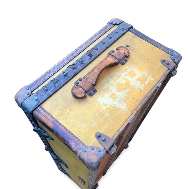 VINTAGE, RRP AS NEW
Step back in time and embrace a piece of history with this rare Louis Vuitton cabin travel trunk, dating back to the early 20th century (circa 1910-1920). Crafted from the iconic 'Vuittonite' canvas, this trunk showcases the craftsmanship and innovation that helped define Louis Vuitton's legacy. The chocolate leather trim and handles add a rich, classic touch to the piece, while the main lock, reinforced with two complementary trunk latches, reflects the brand's dedication to both style and security.  Inside, the trunk reveals its original beige canvas lining, with the inner lid studded for added structure and style. The presence of the original Louis Vuitton tag inside further solidifies its ity and historical significance. This trunk isn't just a functional travel piece; it's a timeless treasure, perfect for adding a sophisticated, vintage flair to your home or office decor. Own a tangible piece of Louis Vuitton history and experience the luxury of the past with this stunning, collectible trunk. Condition Rating: B - VERY GOOD CONDITIONCondition Details: The original orange color has turned to yellow with the effect of time and light. Many signs of darkness and scratches allover. Metal trim shows many cracks and came off in some point. Some green marks on metal parts. Leather trim has darkned and shows some cracks. Keys are missing. The interior shows some darkness and a hole on the lining, on the reverse of the lid. The interior tray is missing. Its general condition is very good, considering its age. Please keep in mind that the trunk dates back to the early twentieth century and therefore has signs of wear due to age and use. Please check the photos carefully and ask if you need to know more details or if you have any doubts.Measurements (cm):Depth: 33.0Height: 53.3Length: 100.3Other Details: Dustbag? NoKeys? NoBox? No Measurments:  width: 330 mm length: 1003 mm height: 533 mm
