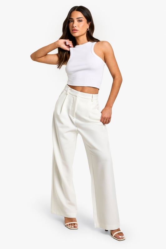 Wide-leg design for a relaxed and comfortable fit
        High-waisted silhouette to elongate the legs
        Side pockets for practicality and style
        Versatile woven fabric suitable for various occasions
        Petite sizing for a perfect fit on smaller frames
    
    These essential wide-leg trousers are a must-have addition to your wardrobe, offering both style and comfort for the fashion-forward woman. The high-waisted design creates a flattering silhouette, while the relaxed wide-leg cut allows for easy movement and a trendy look. Perfect for casual outings or dressed up for more formal events, these trousers can be styled in numerous ways. Pair them with a fitted crop top and strappy sandals for a chic summer ensemble, or dress them up with a tucked-in blouse and heels for a sophisticated office look. The side pockets add a practical touch, making these trousers ideal for everyday wear. Whether you're heading to a family gathering or a casual lunch with friends, these versatile trousers will keep you looking effortlessly stylish and feeling confident throughout the day.