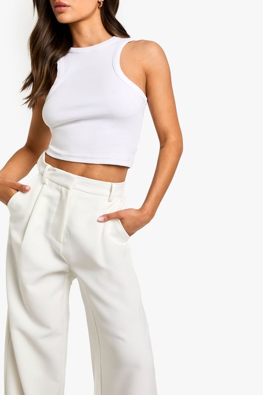 Wide-leg design for a relaxed and comfortable fit
        High-waisted silhouette to elongate the legs
        Side pockets for practicality and style
        Versatile woven fabric suitable for various occasions
        Petite sizing for a perfect fit on smaller frames
    
    These essential wide-leg trousers are a must-have addition to your wardrobe, offering both style and comfort for the fashion-forward woman. The high-waisted design creates a flattering silhouette, while the relaxed wide-leg cut allows for easy movement and a trendy look. Perfect for casual outings or dressed up for more formal events, these trousers can be styled in numerous ways. Pair them with a fitted crop top and strappy sandals for a chic summer ensemble, or dress them up with a tucked-in blouse and heels for a sophisticated office look. The side pockets add a practical touch, making these trousers ideal for everyday wear. Whether you're heading to a family gathering or a casual lunch with friends, these versatile trousers will keep you looking effortlessly stylish and feeling confident throughout the day.