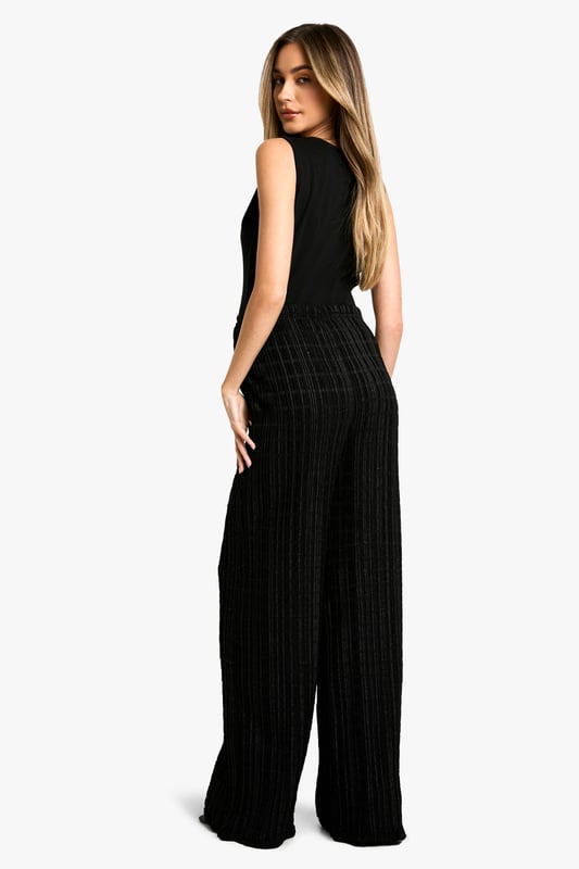 Textured wide-leg trousers with a crinkle effect
        Comfortable jersey fabric for all-day wear
        Drawstring waist for adjustable fit
        Relaxed silhouette perfect for maternity wear
        Versatile design suitable for various casual occasions
    
    Embrace comfort and style during your pregnancy with these textured wide-leg trousers from Boohoo. The crinkle effect adds a touch of interest to the relaxed silhouette, while the jersey fabric ensures all-day comfort as your body changes. The drawstring waist allows for easy adjustment, accommodating your growing bump with ease. Style these trousers with a fitted tank top and a lightweight blazer for a polished yet comfortable look perfect for family gatherings or casual outings. For a more laid-back ensemble, pair with a loose-fitting tee and trainers. The versatile design of these trousers makes them a wardrobe staple that can be dressed up or down to suit various casual occasions throughout your pregnancy and beyond.