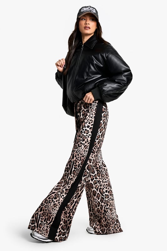 Eye-catching leopard print pattern
        Flattering wide-leg silhouette
        Contrasting side stripes for added flair
        High-waisted design for a lengthening effect
        Lightweight woven fabric for all-day comfort
    
    Make a bold statement with these striking leopard print trousers, perfect for the fashion-forward Boohoo girl. The wide-leg cut offers a relaxed fit that's both on-trend and comfortable, while the high waist creates a flattering silhouette. The contrasting side stripes add a sporty edge, making these trousers versatile enough for various casual occasions. Style them with a cropped black top and trainers for a laid-back daytime look, or dress them up with a sleek bodysuit and heels for a night out with friends. These trousers are ideal for family gatherings, brunch dates, or casual shopping trips. The lightweight fabric ensures you'll stay cool and comfortable, no matter where your day takes you. Embrace your wild side and stand out from the crowd in these eye-catching trousers that perfectly blend comfort with cutting-edge style.