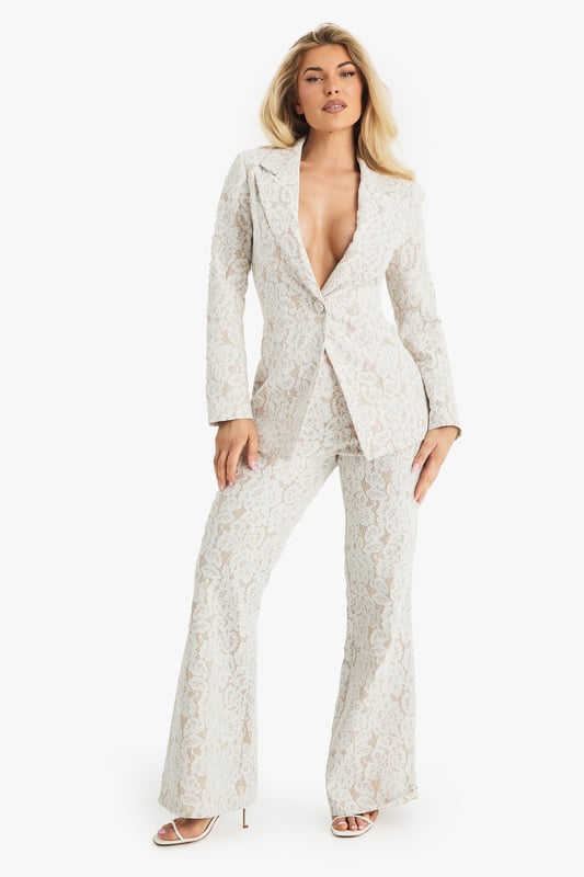 Exquisite lace flared trousers with matching blazer
        High-waisted design for a flattering silhouette
        Elegant woven crepe fabric with intricate lace pattern
        Flared leg cut for a dramatic, fashion-forward look
        Versatile two-piece set suitable for various formal occasions
    
    Make a lasting impression with these stunning lace flared trousers from Boohoo. Perfect for the fashion-forward woman who loves to stand out, these trousers offer a bold and sophisticated look for any special event. The high-waisted design accentuates your curves, while the flared leg creates a dramatic silhouette that's sure to turn heads. Pair with the matching blazer for a coordinated ensemble that exudes confidence and style. Ideal for weddings, formal parties, or glamorous nights out, these trousers can be dressed up or down to suit your needs. For a chic daytime look, style with a simple camisole and strappy heels. For evening events, amp up the glamour with statement jewellery and a sleek clutch. The versatility of this piece ensures it will become a go-to in your wardrobe for seasons to come.