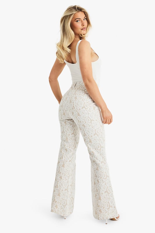 Exquisite lace flared trousers with matching blazer
        High-waisted design for a flattering silhouette
        Elegant woven crepe fabric with intricate lace pattern
        Flared leg cut for a dramatic, fashion-forward look
        Versatile two-piece set suitable for various formal occasions
    
    Make a lasting impression with these stunning lace flared trousers from Boohoo. Perfect for the fashion-forward woman who loves to stand out, these trousers offer a bold and sophisticated look for any special event. The high-waisted design accentuates your curves, while the flared leg creates a dramatic silhouette that's sure to turn heads. Pair with the matching blazer for a coordinated ensemble that exudes confidence and style. Ideal for weddings, formal parties, or glamorous nights out, these trousers can be dressed up or down to suit your needs. For a chic daytime look, style with a simple camisole and strappy heels. For evening events, amp up the glamour with statement jewellery and a sleek clutch. The versatility of this piece ensures it will become a go-to in your wardrobe for seasons to come.