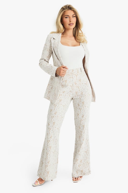 Exquisite lace flared trousers with matching blazer
        High-waisted design for a flattering silhouette
        Elegant woven crepe fabric with intricate lace pattern
        Flared leg cut for a dramatic, fashion-forward look
        Versatile two-piece set suitable for various formal occasions
    
    Make a lasting impression with these stunning lace flared trousers from Boohoo. Perfect for the fashion-forward woman who loves to stand out, these trousers offer a bold and sophisticated look for any special event. The high-waisted design accentuates your curves, while the flared leg creates a dramatic silhouette that's sure to turn heads. Pair with the matching blazer for a coordinated ensemble that exudes confidence and style. Ideal for weddings, formal parties, or glamorous nights out, these trousers can be dressed up or down to suit your needs. For a chic daytime look, style with a simple camisole and strappy heels. For evening events, amp up the glamour with statement jewellery and a sleek clutch. The versatility of this piece ensures it will become a go-to in your wardrobe for seasons to come.