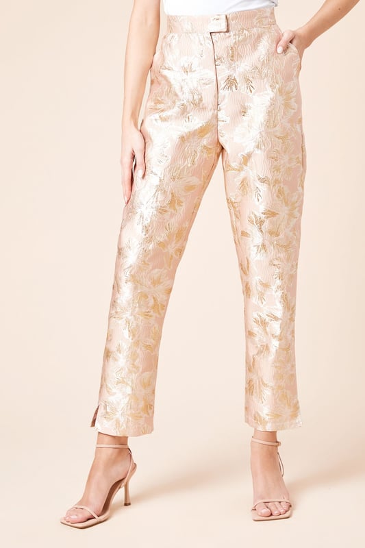 Elegant jacquard fabric with a lustrous finish and textured floral pattern
        Sophisticated tapered fit that narrows towards the ankle for a refined silhouette
        Practical side pockets for essential items
        Flattering high-waist design with a sleek waistband
        Ankle-length cut with subtle side slits for enhanced movement and style
    
    These Dorothy Perkins Tailored Jacquard Tapered Trousers offer the perfect balance of sophistication and contemporary style. The exquisite jacquard weave creates a textured finish that catches the light beautifully, making these trousers ideal for special occasions. Style with a crisp white blouse and strappy heels as shown for elegant wedding guest attire, or pair with a coordinating jacquard blazer for a striking head-to-toe look at formal events. The tapered silhouette creates a flattering shape that works wonderfully for race day ensembles or graduation ceremonies. For evening affairs, match with a simple camisole and statement jewellery to let the trousers take centre stage. These versatile occasion trousers transition seamlessly from day to night, offering endless styling possibilities for the fashion-conscious woman who appreciates refined elegance with a contemporary twist.