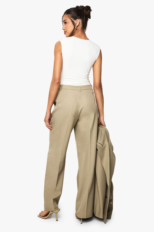 Tailored straight leg trousers with a textured woven finish for added dimension
        Flattering high-waist design with front pleats for a sophisticated silhouette
        Clean, straight-leg cut that creates a lengthening effect on the legs
        Versatile design that transitions seamlessly from office to evening occasions
        Subtle stretch in the fabric allows for comfortable movement throughout the day
    
    Make a bold statement with these tailored straight leg trousers from Boohoo. The textured woven crepe fabric adds subtle interest while maintaining a sleek appearance perfect for contemporary styling. Pair with the matching oversized blazer for a coordinated power suit that commands attention at your next night out, or style with a fitted bodysuit and strappy heels for a chic evening look. The high-waisted design with front pleats creates a flattering shape that works brilliantly with both cropped tops and tucked-in blouses. These trousers offer the perfect balance of structure and comfort, making them ideal for dancing the night away or enjoying drinks with friends. The straight leg cut provides a timeless silhouette that will remain a wardrobe staple for seasons to come, easily dressed up with statement jewellery or pared back with minimalist accessories.