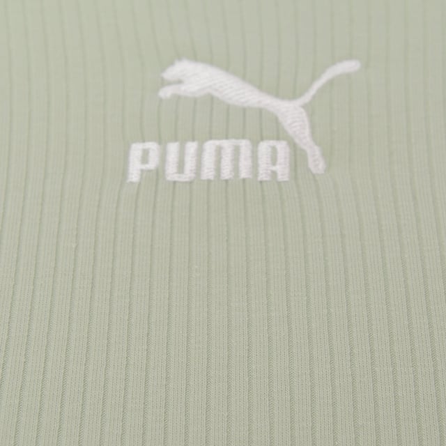 Main: 100% Cotton. The Puma Classic long flare sleeve scoop back crop top in light green is a stylish and versatile piece that's perfect for both active days and casual wear. Its form-fitting design and contrasting panels add a sporty touch, while the scoop back offers a hint of elegance. Made with a blend of cotton and elastane, it promises comfort and flexibility, making it an excellent addition to any wardrobe. Whether you're heading to the gym or meeting friends, this crop top combines fashion with function in the most delightful way.