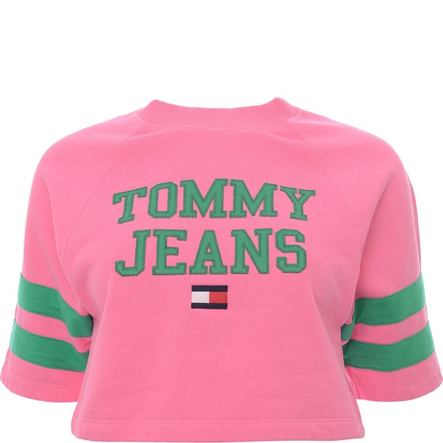 Main: 100% Cotton. The Tommy Jeans short sleeve sweatshirt in pink with green branding offers a striking contrast that's sure to stand out. This trendy piece combines the classic comfort of a sweatshirt with the coolness of short sleeves, perfect for those transitional seasons or a stylish layering option. The vibrant pink hue paired with the bold green logo creates a fresh and preppy look, embodying the spirit of the Tommy Hilfiger brand. Whether you're out for a casual day or looking to add a pop of color to your outfit, this sweatshirt is a versatile addition to any wardrobe.