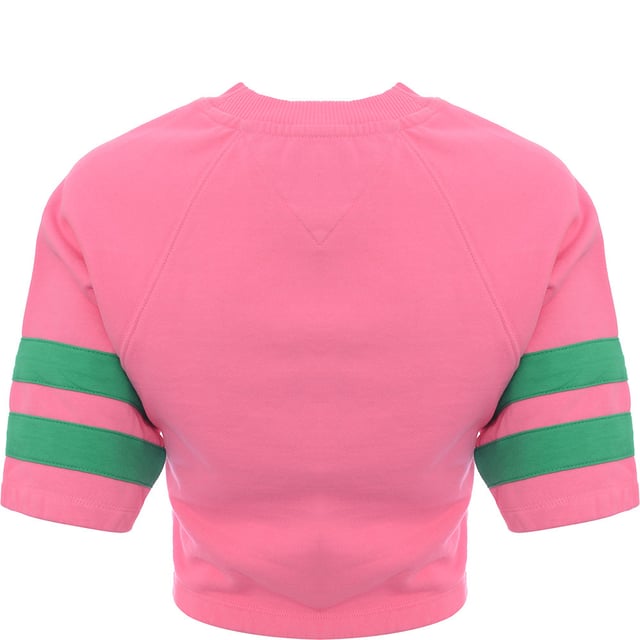 Main: 100% Cotton. The Tommy Jeans short sleeve sweatshirt in pink with green branding offers a striking contrast that's sure to stand out. This trendy piece combines the classic comfort of a sweatshirt with the coolness of short sleeves, perfect for those transitional seasons or a stylish layering option. The vibrant pink hue paired with the bold green logo creates a fresh and preppy look, embodying the spirit of the Tommy Hilfiger brand. Whether you're out for a casual day or looking to add a pop of color to your outfit, this sweatshirt is a versatile addition to any wardrobe.